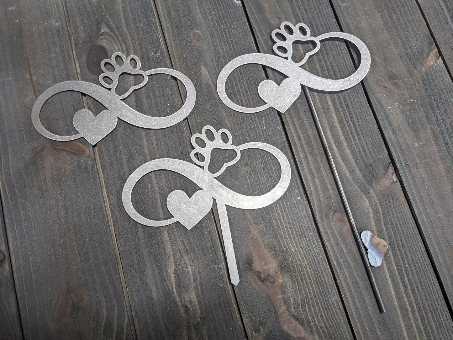 Examples of the variations of the Infiniti dog paw garden stake. options include the Infiniti dog paw metal sign without a stake, with a short stake, and with a longer welded stake. personalization options are also available.